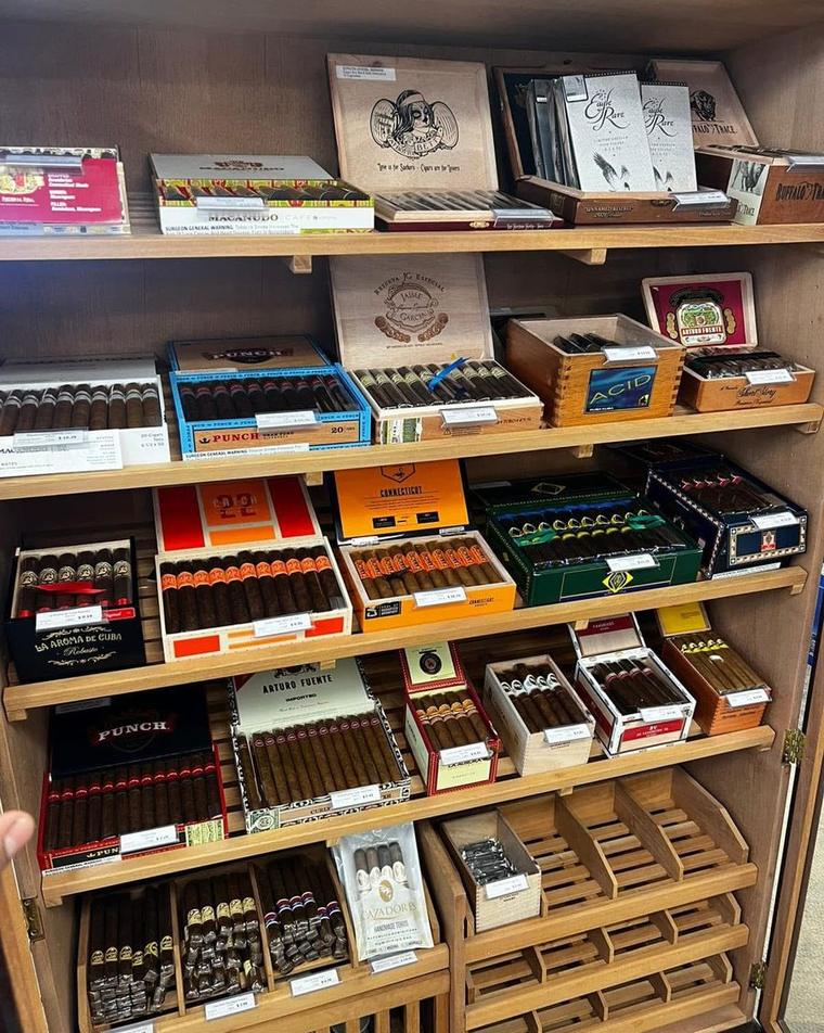 Cigar humidor at JOCO Liquor & Vape in Olathe, Kansas, stocked with Macanudo, Punch, Arturo Fuente, Acid and other brands